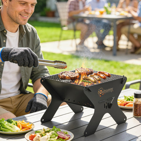 Black metal x-shaped outsunny 2-in-1 portable bbq grill with flame and food cooking on grill grate, includes carry bag
