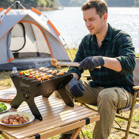 Black foldable charcoal bbq grill with outsunny branding, grill grate, carry bag, gloves, and tabletop design