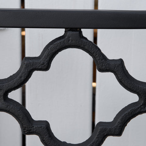 Black wrought iron garden bench railing with ornate cast iron quatrefoil design for yard or patio loveseat