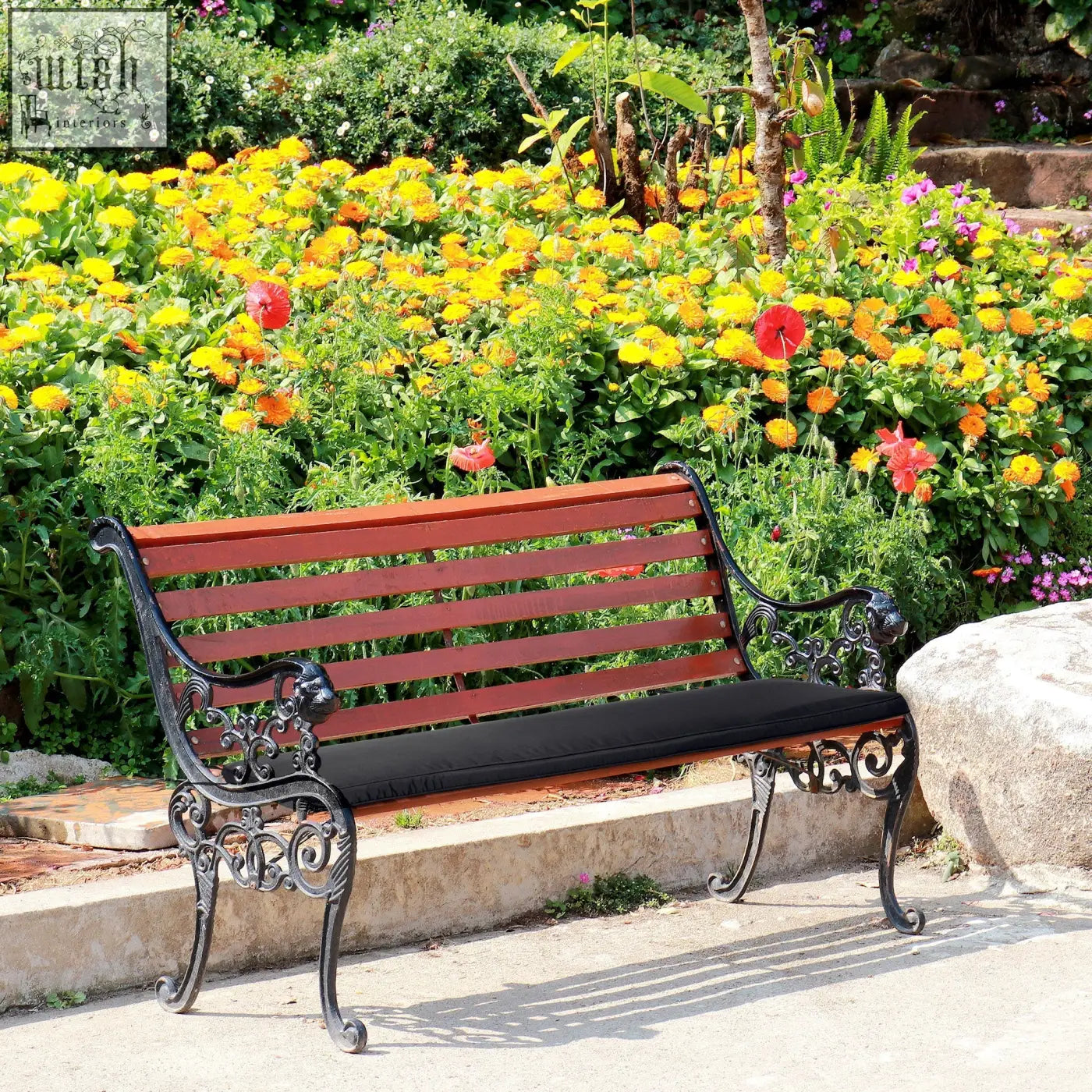 Classic wrought iron bench with reddish brown wooden slats and black polyester fabric bench cushion with two tie fastenings