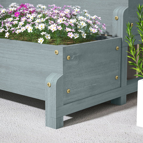 Gray fir wood planter box with drainage holes and gold screws blooming pink white and purple flowers outdoors