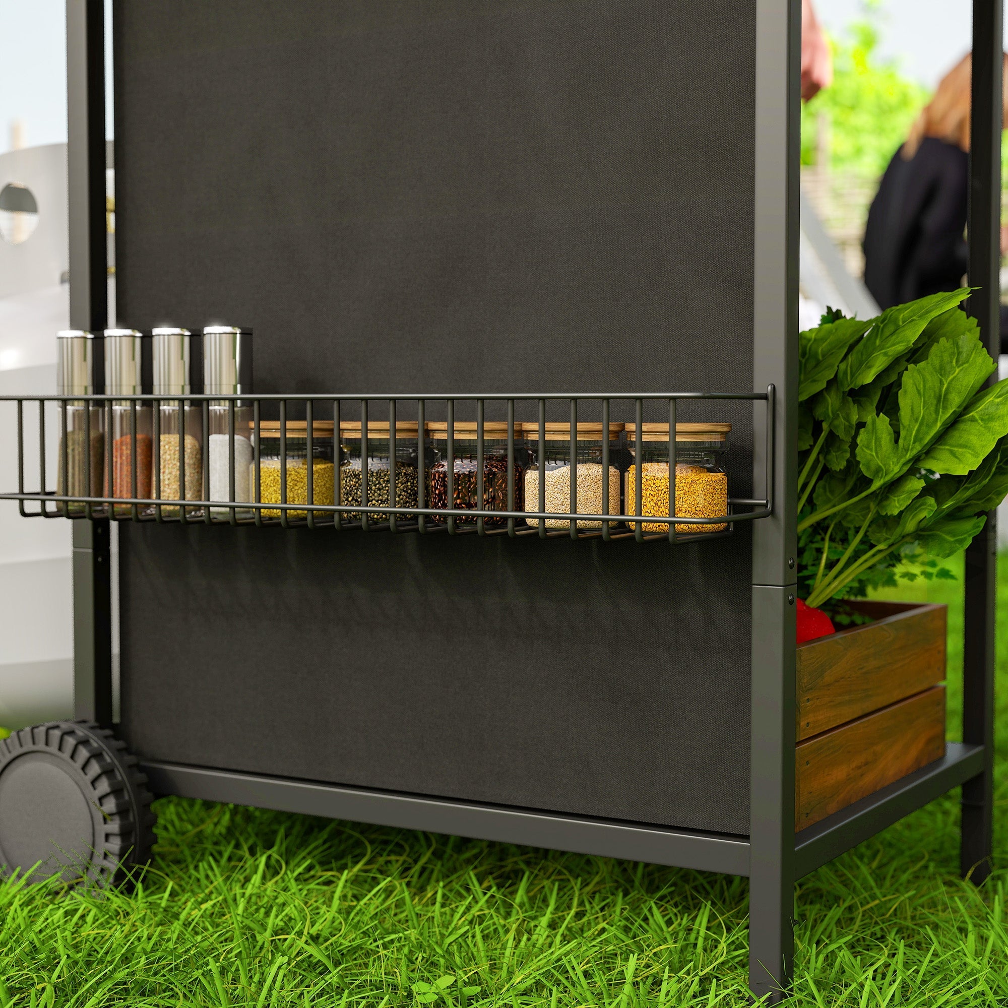 Black metal spice rack with wire shelf holding glass jars of colorful spices and wooden crate on burner gas bbq grill