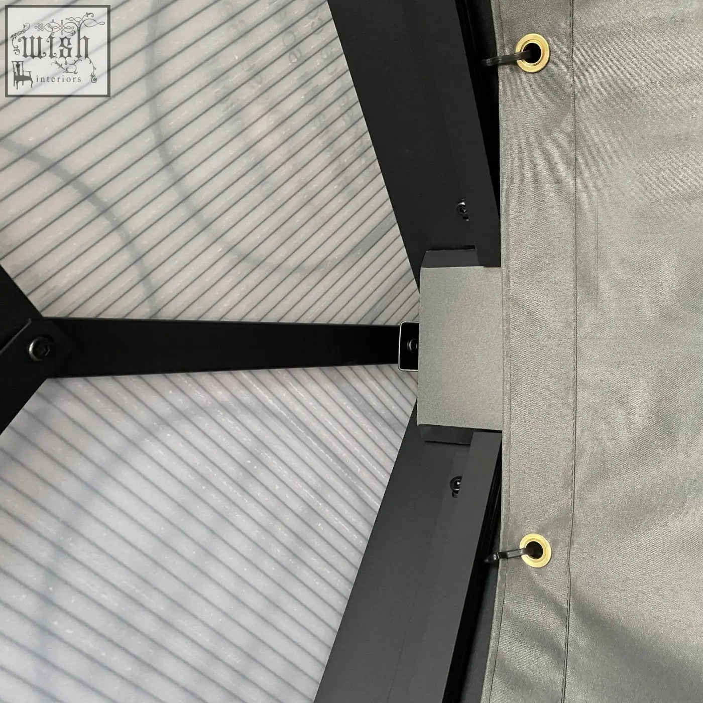 Gray fabric canopy with gold grommets attached to black aluminium frame of outsunny garden gazebo with hardtop roof