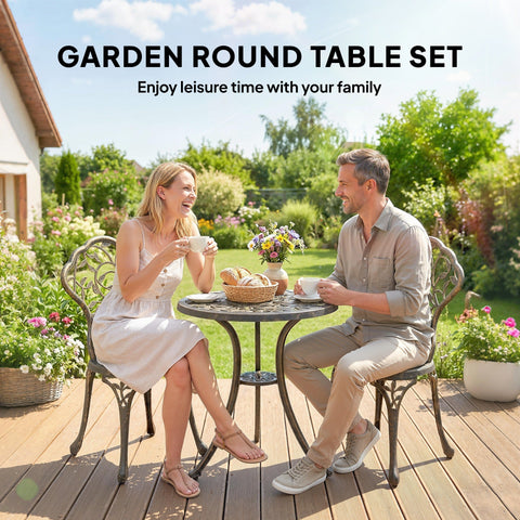 Black wrought iron bistro set with two chairs featuring ornate scrollwork legs and pedestal base for outdoor patio use