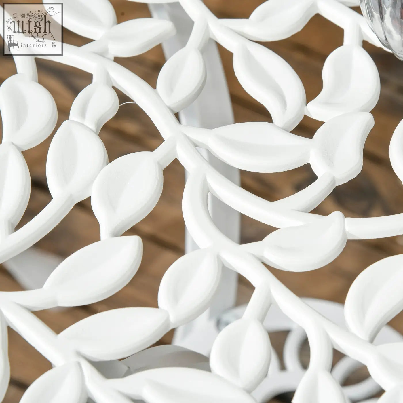 White painted metal garden stool with intricate cut-out leaf design part of outsunny bistro set with two chairs