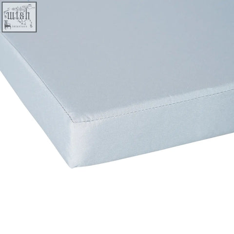Light gray outsunny single seat cushion with smooth textured fabric and stitched edges for outdoor rattan furniture