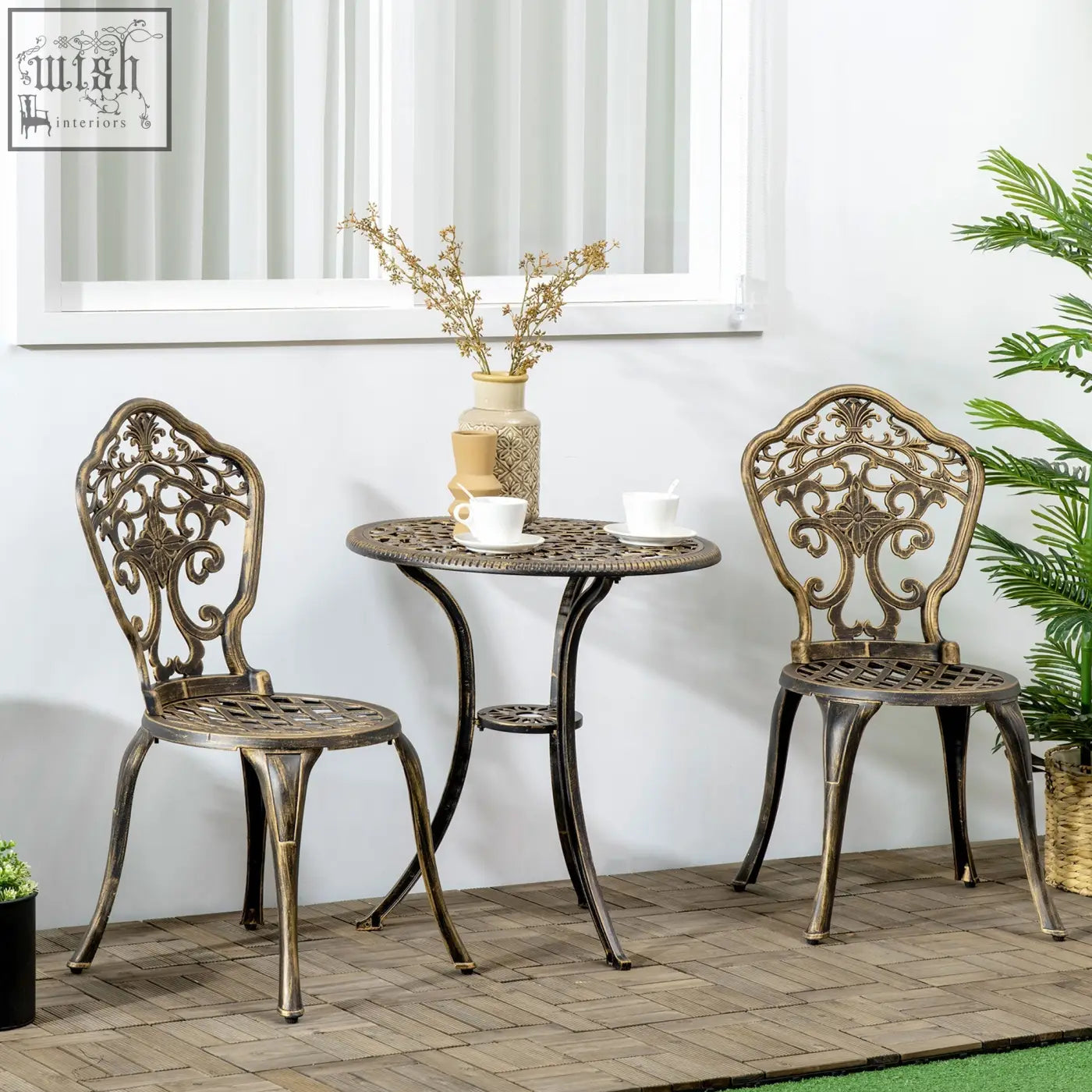 Antique bronze finished cast aluminium bistro set with ornate scrollwork chairs and round coffee table for patio use