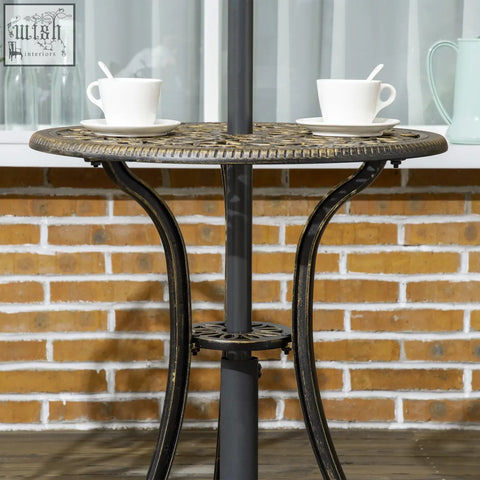 Black wrought iron cast aluminium coffee table with ornate circular top and curved legs in outsunny bistro set