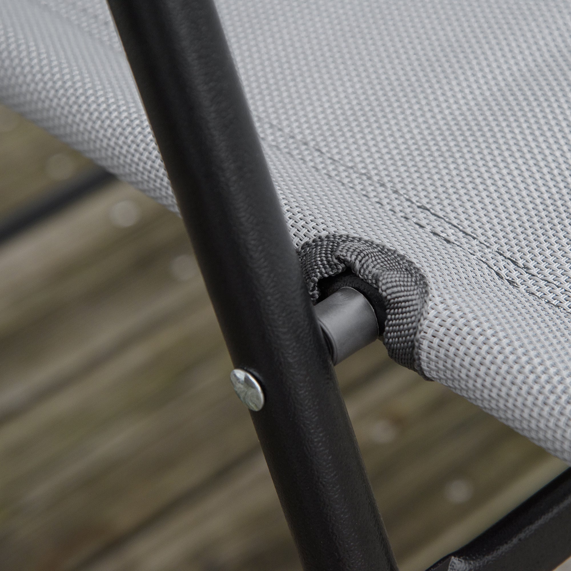 Gray woven sling fabric stretched over black metal frame of outsunny folding chairs in outdoor furniture set