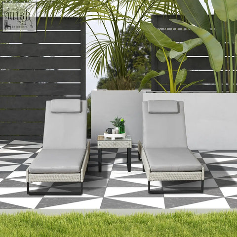 Gray woven wicker lounge chairs with longline seat cushions black metal frames and glass top coffee table
