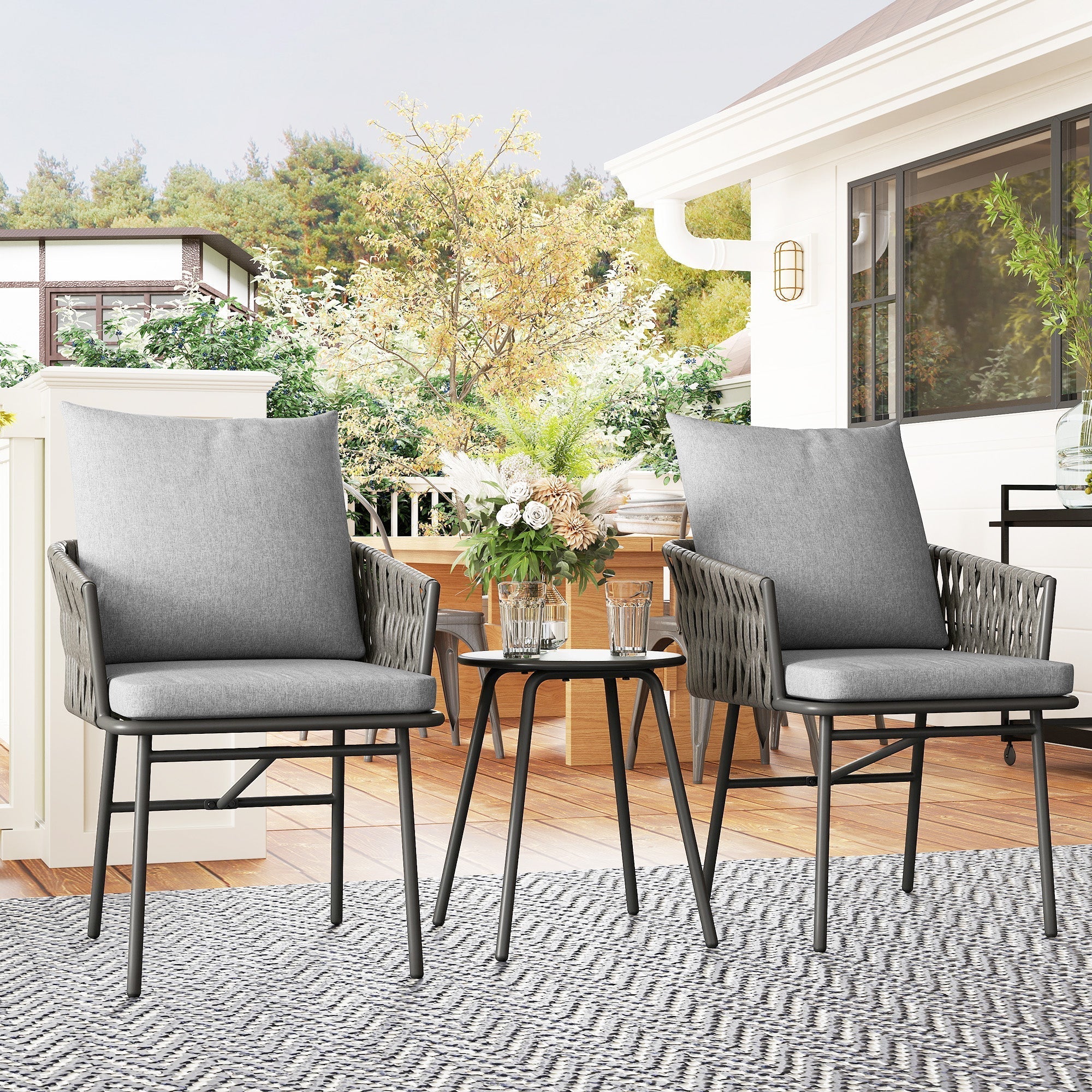 Gray woven wicker patio furniture set with rust-resistant steel frame metal-topped table and cushions for outdoor use