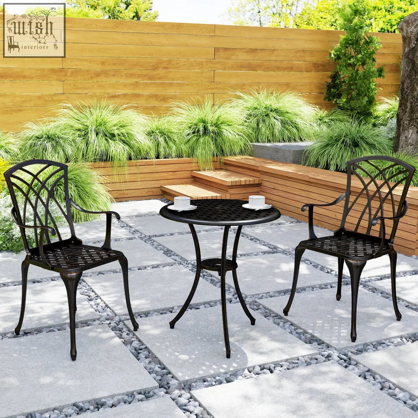 Black wrought iron cast aluminium garden furniture set with round table and lattice back chairs in bronze tone