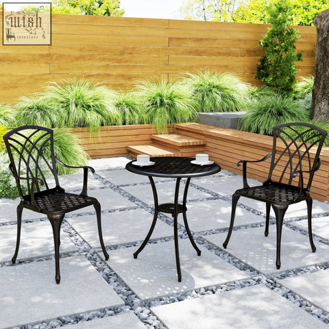 Black wrought iron cast aluminium garden furniture set with round table and lattice back chairs in bronze tone