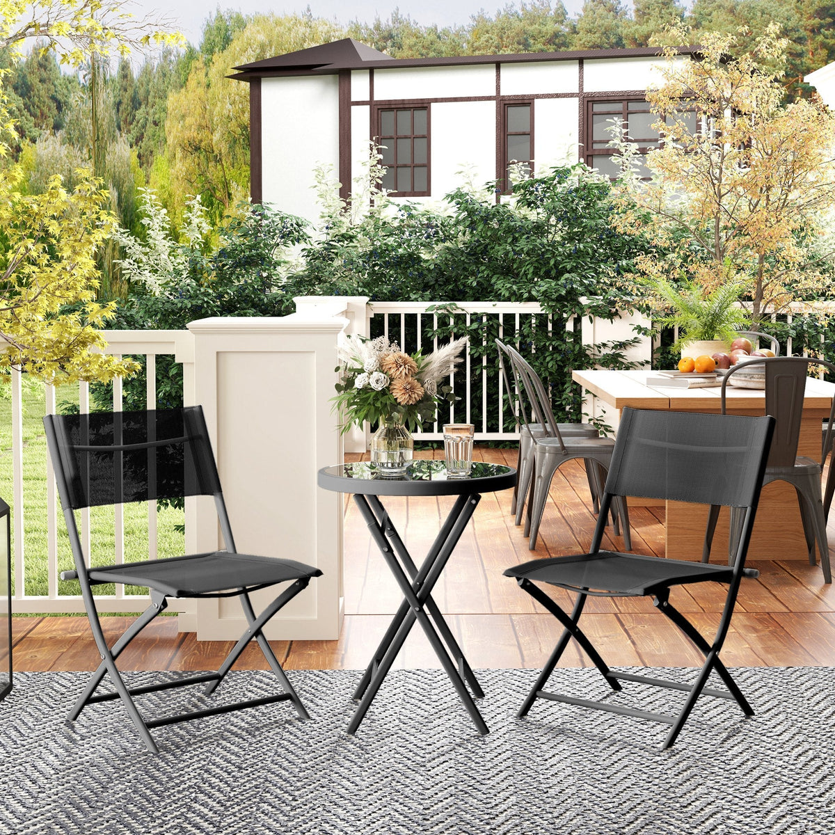 Black foldable patio chairs with breathable mesh backs from the outsunny outdoor bistro set with tempered glass table