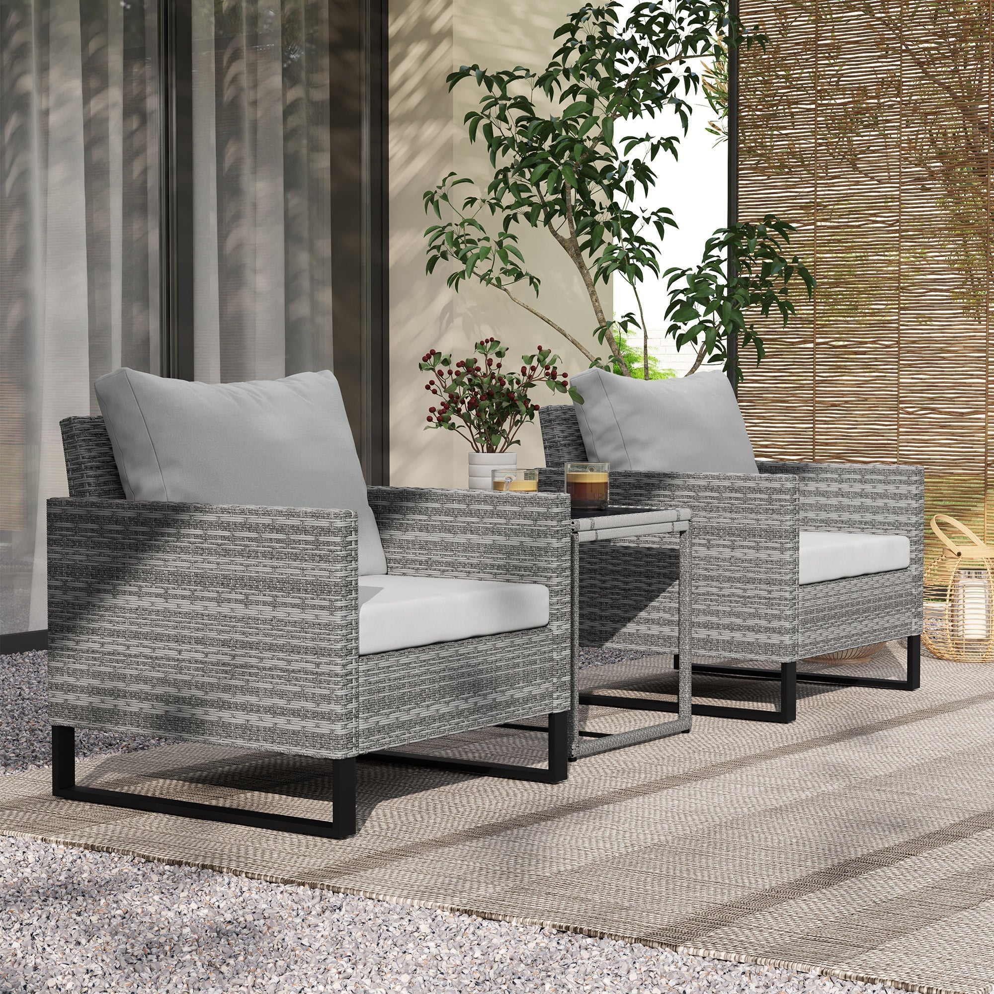 Gray woven wicker outdoor armchairs with white cushions and black legs in outsunny rattan bistro set with glass table