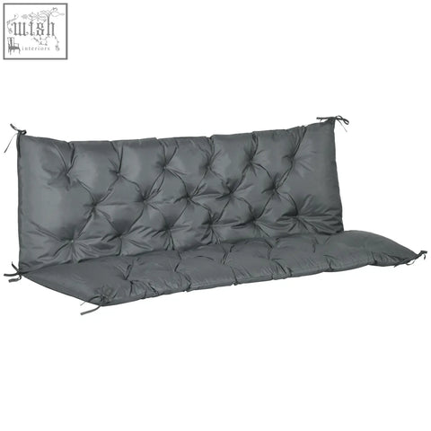 Dark gray tufted outdoor bench cushion with quilted polyester fabric cover and tie fastenings for secure fit