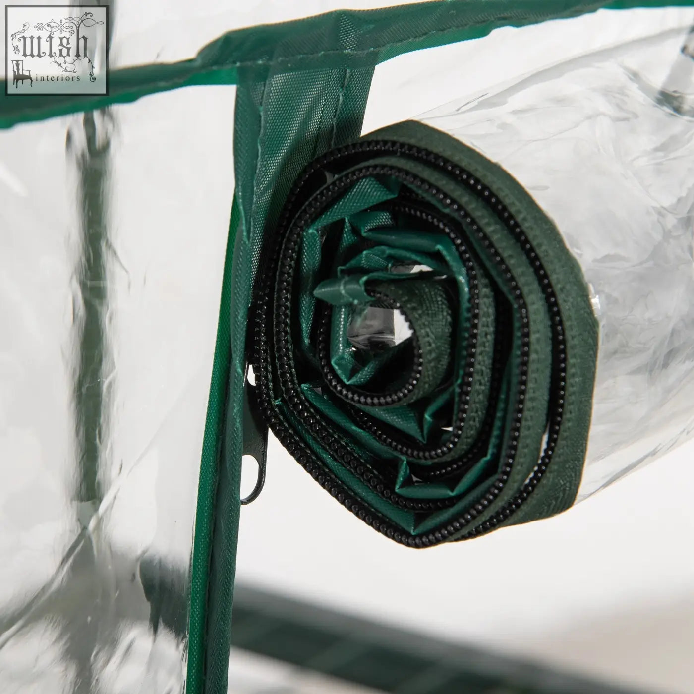 A rolled-up green plastic cover with a black zipper for outsunny 3 tier mini greenhouse 69l x 49w roll-up door