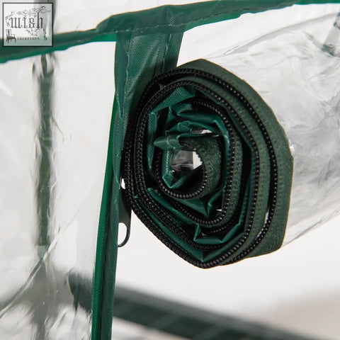 A rolled-up green plastic cover with a black zipper for outsunny 3 tier mini greenhouse 69l x 49w roll-up door