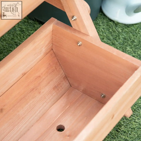 Light brown wooden outsunny raised garden bed with hinged lid and visible screws for flowers veggies herbs