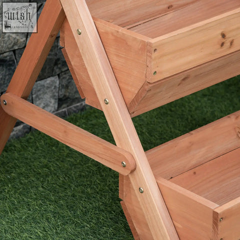 Light brown wooden a-frame raised garden bed with two tiers and visible metal screws for flowers herbs and veggies