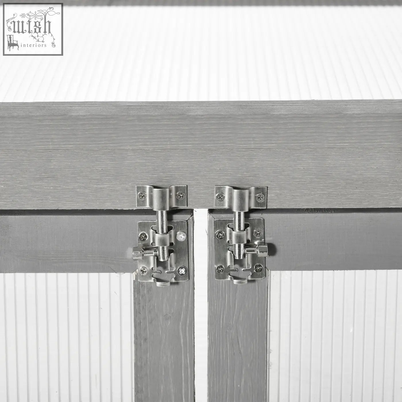 Silver-toned metal slide latch on dark grey fir wood cabinet doors of outsunny greenhouse with polycarbonate panels