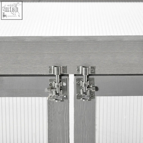 Silver-toned metal slide latch on dark grey fir wood cabinet doors of outsunny greenhouse with polycarbonate panels