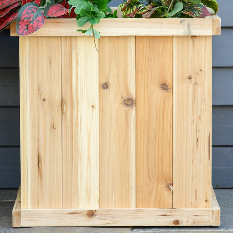 Outsunny 37l light wood garden planter with vertical planks and base holding green foliage designed to drain excess water