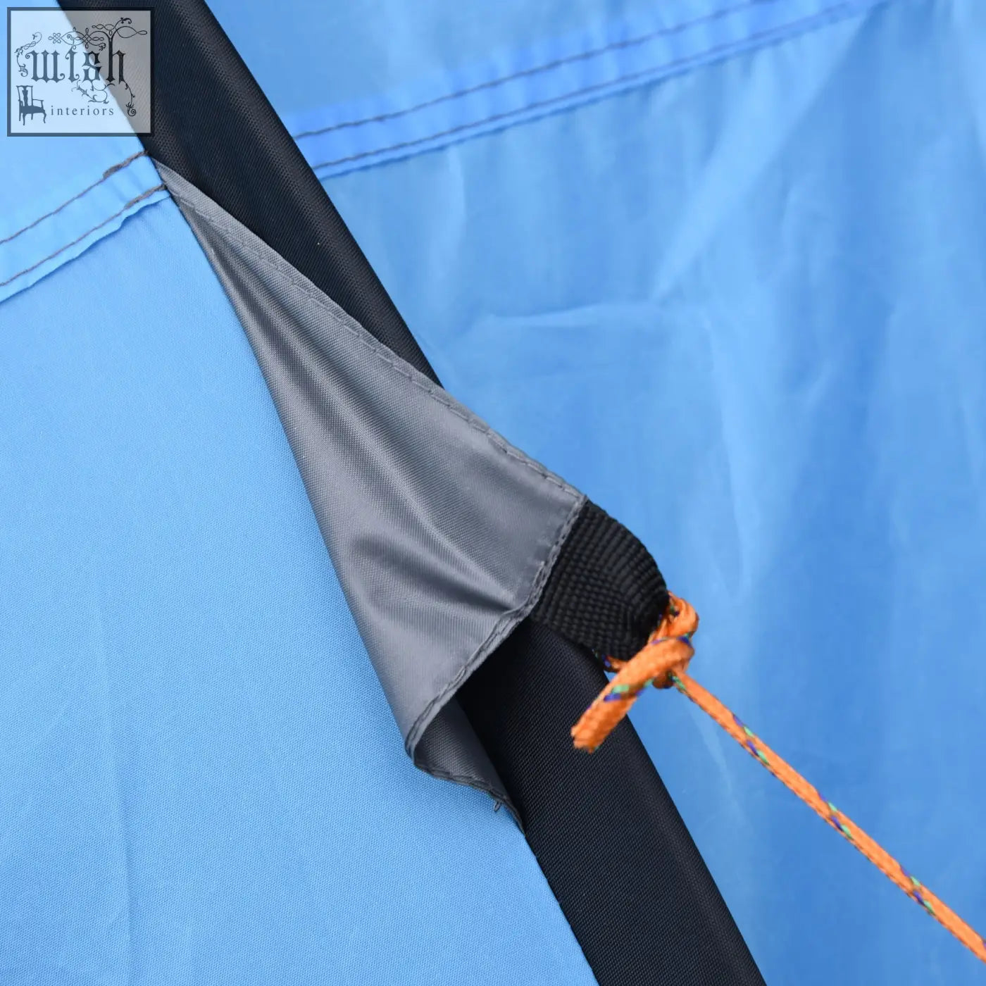 Corner of a sky blue outsunny camping tent with mesh windows black strap and orange guy line for outdoor trips