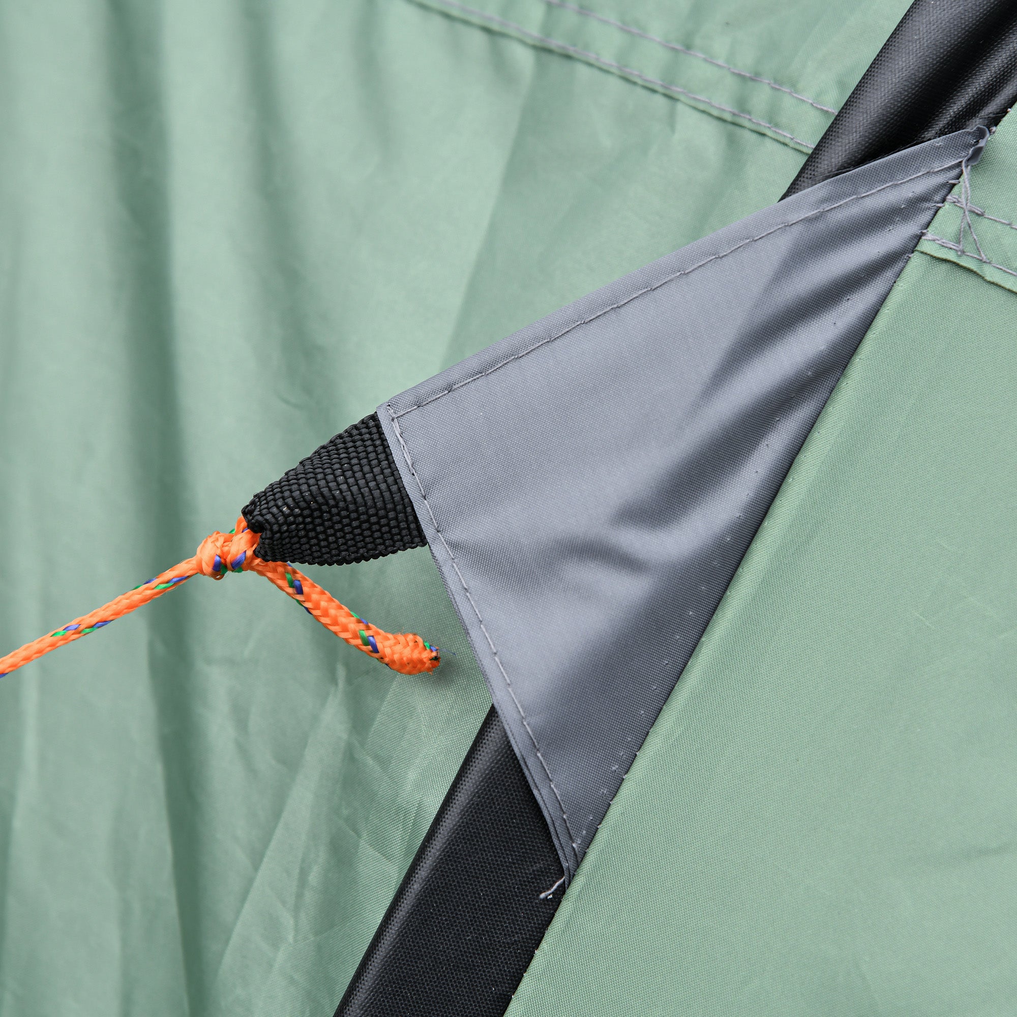 Corner of a dark green outsunny pop-up camping tent with gray patch, black mesh sleeve, and orange cord for easy access mesh windows