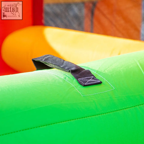 Bright green outsunny 4 in 1 bouncy castle with black handle and reinforced stitching for kids with ground stakes option