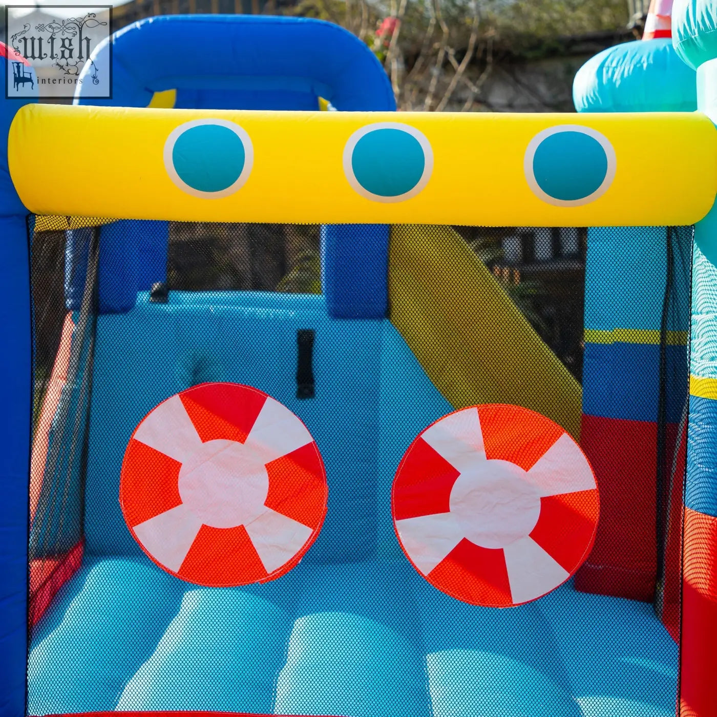 Bright blue outsunny bouncy castle with climbing wall and life preserver decals includes ground stakes for safety