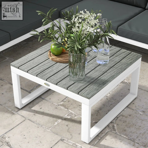 Modern outdoor coffee table with gray wood grain top and white powder coated steel frame for patio corner sofa set