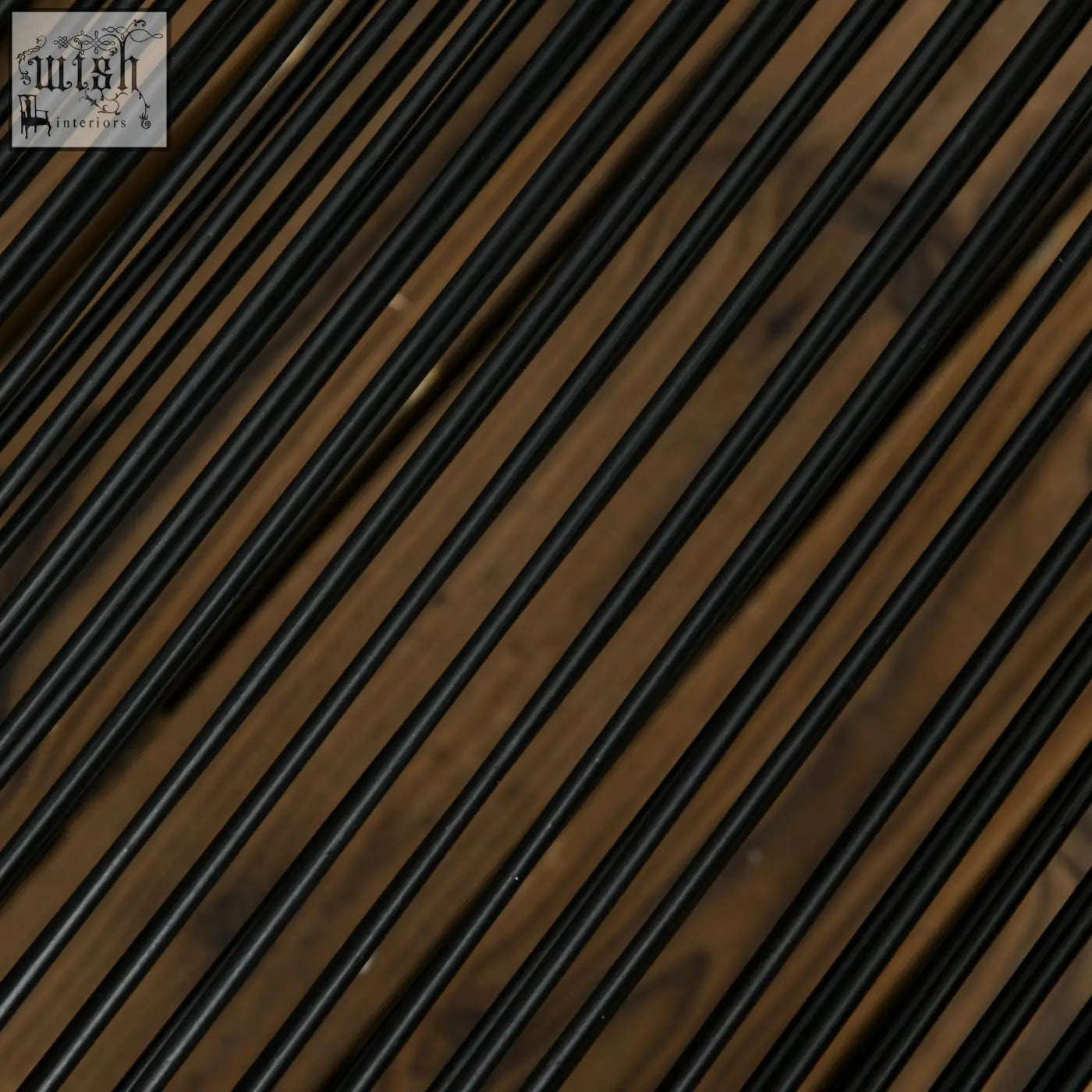 Black cylindrical rods arranged diagonally on wooden surface in a seater rattan cube garden furniture set