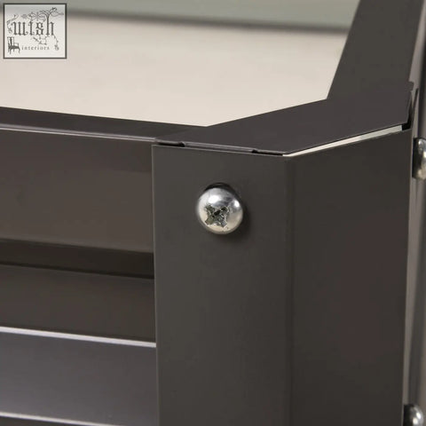 Dark gray metal cabinet corner with shiny silver screw head on outsunny light grey galvanised steel garden bed frame