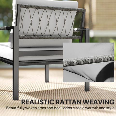 Modern outdoor armchair with black metal frame gray woven rattan and plush white cushions in a garden furniture set with coffee table