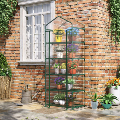 Green metal framed greenhouse with clear glass panels, roll up door, plastic cover, and four shelves for plants