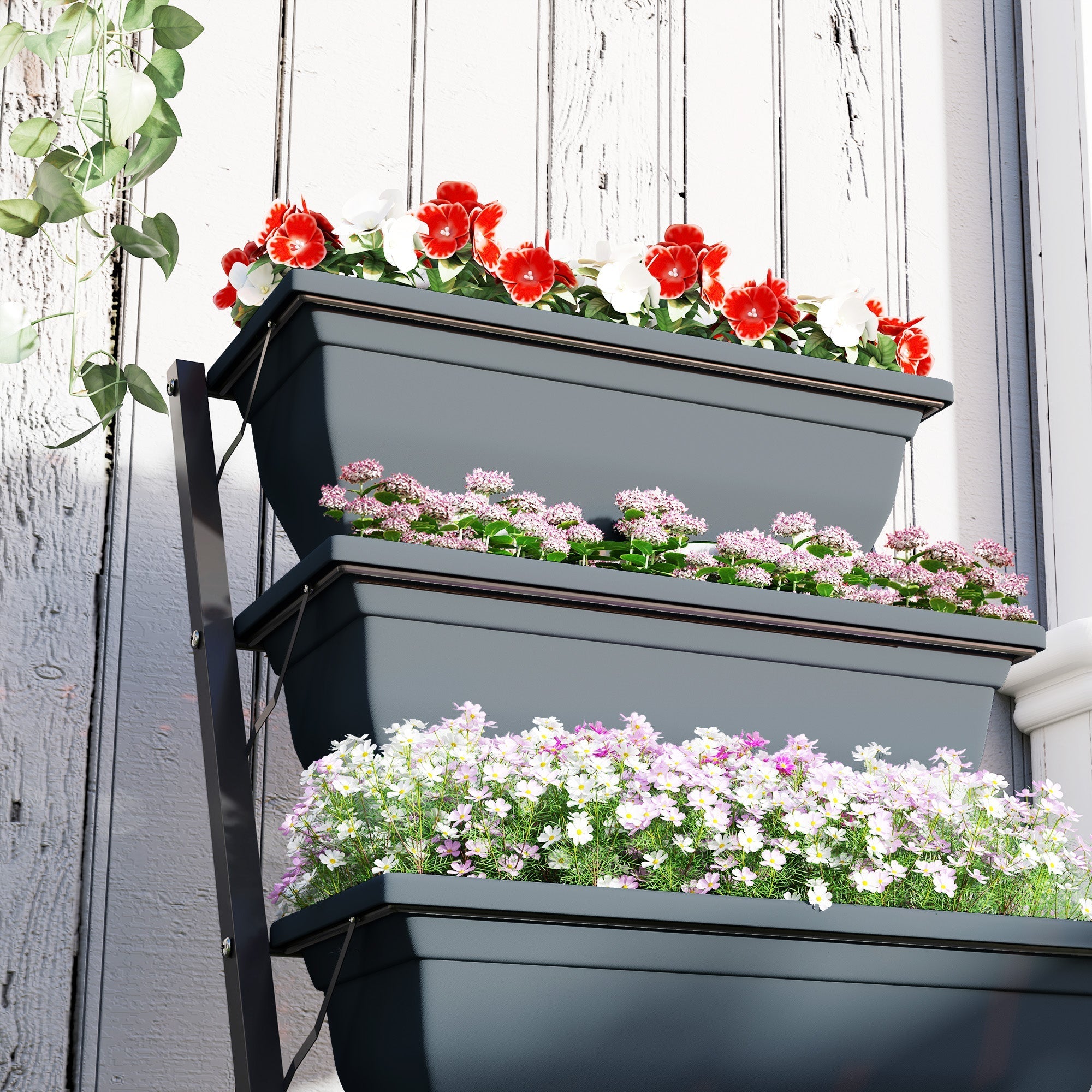 Gray Outsunny 5-tier plastic plant stand with drainage holes stacked with red, pink, purple, and white flowers