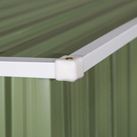 White plastic corner joint connecting two white metal beams on green base of outsunny garden storage shed foundation kit