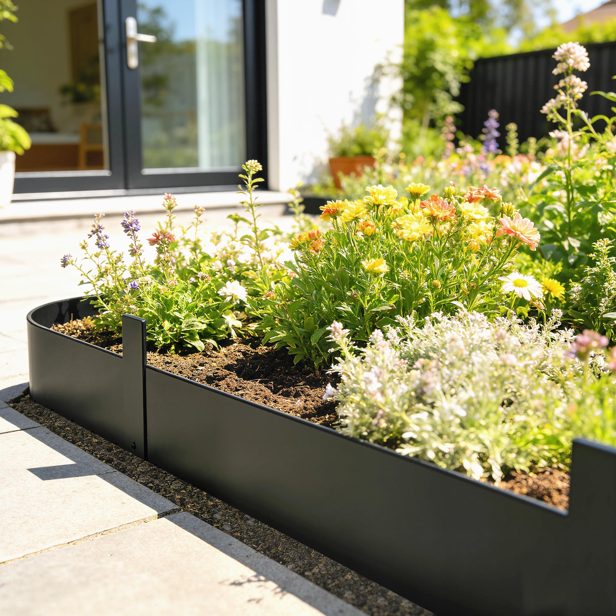 Black metal garden fence panels by Outsunny with raised edges for keeping mulch and flexible metal design