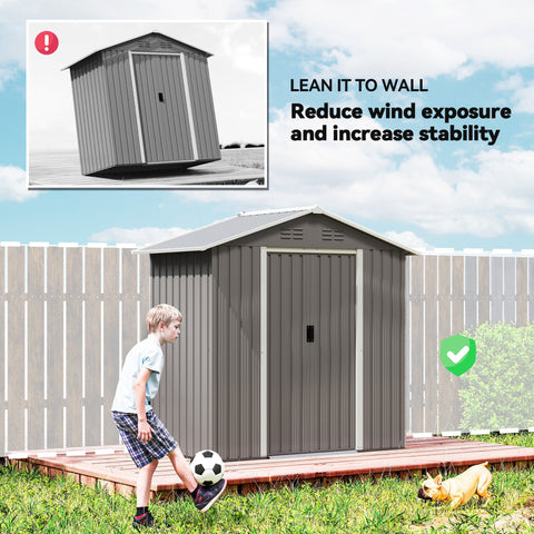 Gray metal garden storage shed with white trim made of galvanized steel for outdoor storage use