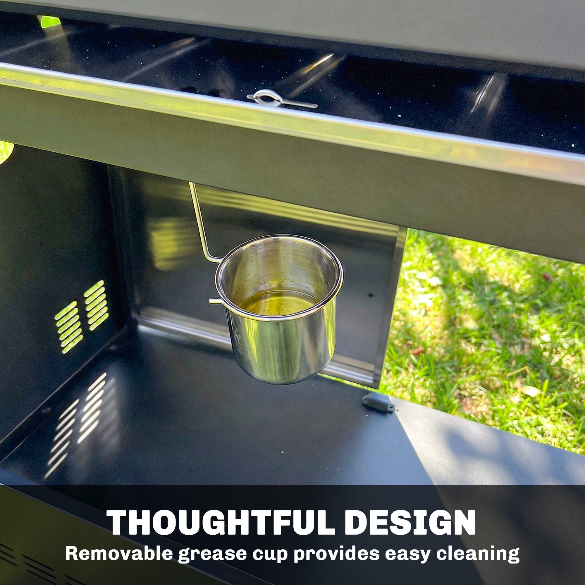 A shiny stainless steel grease cup with handle hanging on the outsunny gas grill with warming rack side tables and cabinet