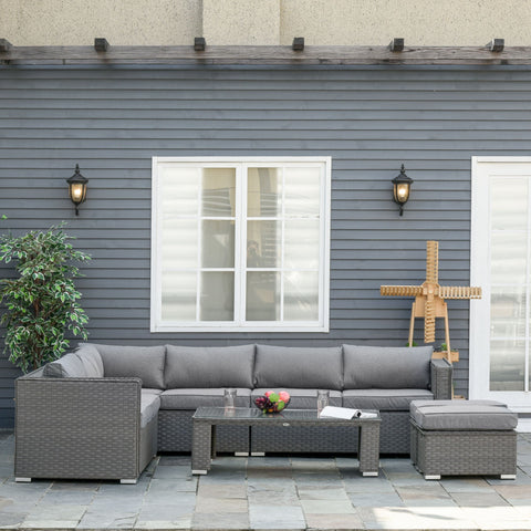 Gray woven wicker double corner sofa set with padded cushions and glass top coffee table for outdoor use