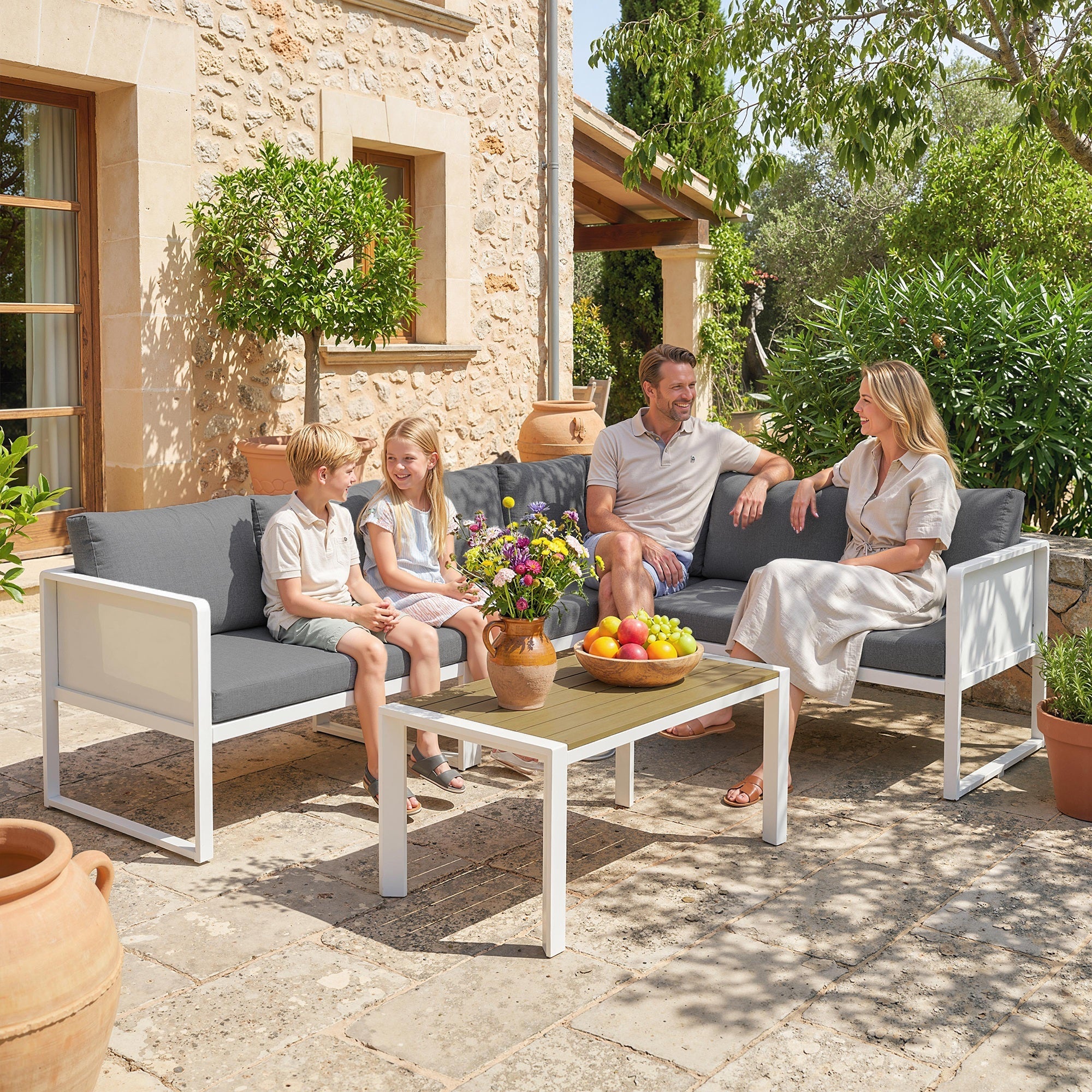Modern white metal garden furniture set with gray cushions and faux wood table perfect for outdoor seating
