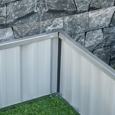 Silver corrugated metal planter box corner with gray stone wall backdrop for starting your garden bed easy