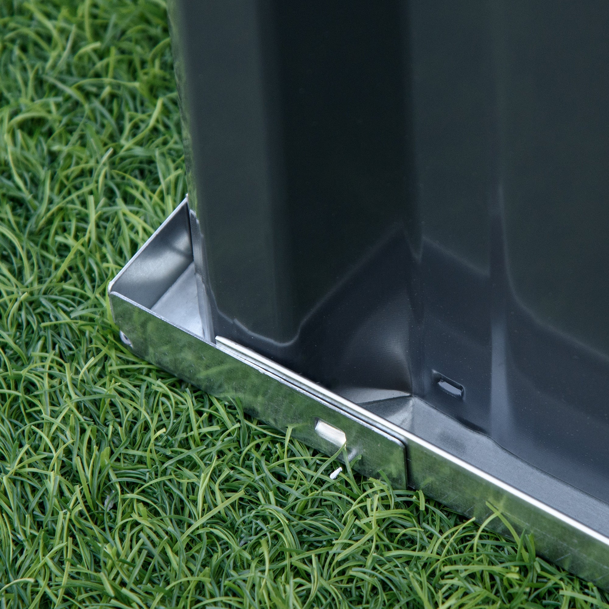 Dark gray plastic planter box with shiny metallic base for backyard garden bed to start growing veggies and herbs
