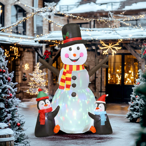Inflatable snowman with led lights wearing a striped scarf and black top hat with two penguins and ground stakes