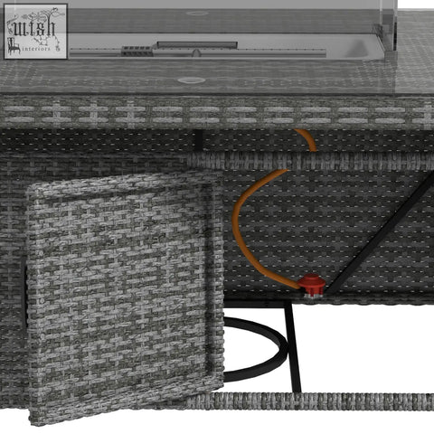 Gray woven wicker outdoor gas pit table with black metal legs and curved orange hose in six armchairs garden furniture set
