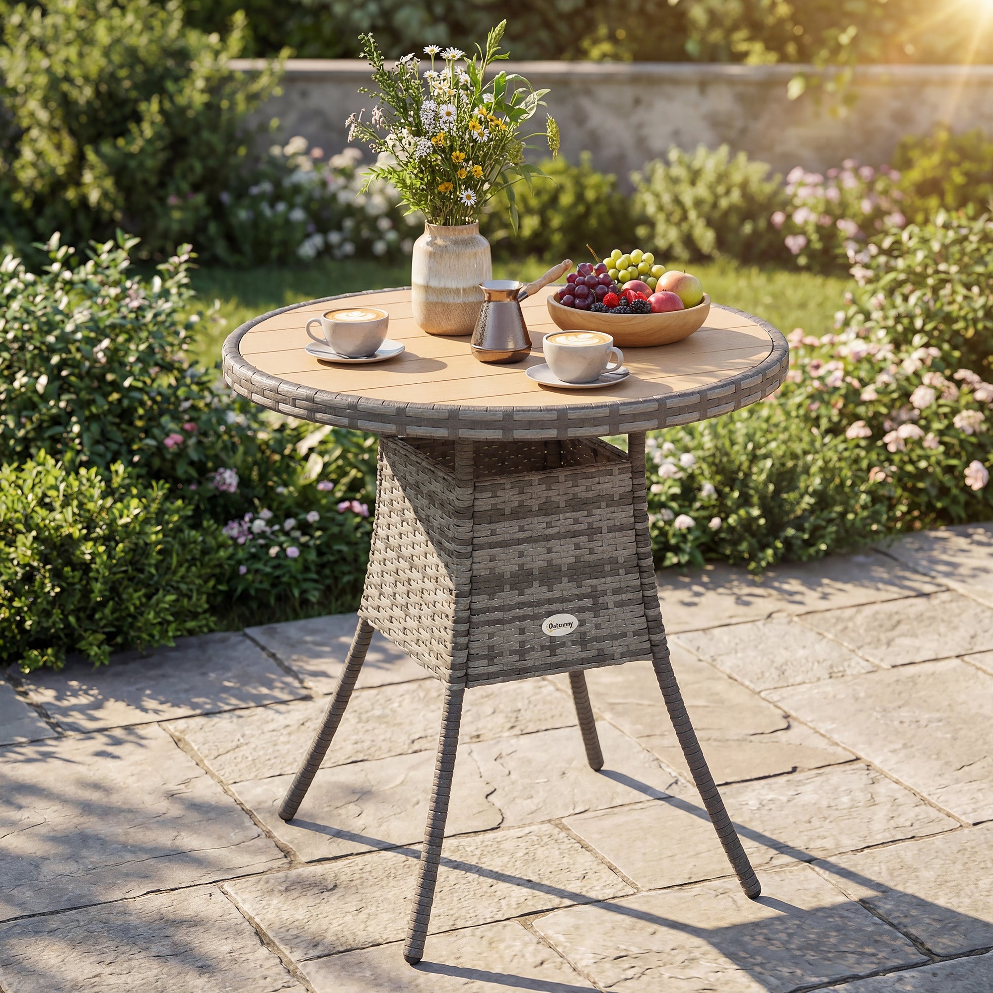 Gray woven rattan dining table with round natural wood top and storage, featuring galvanised steel frame for outdoor use