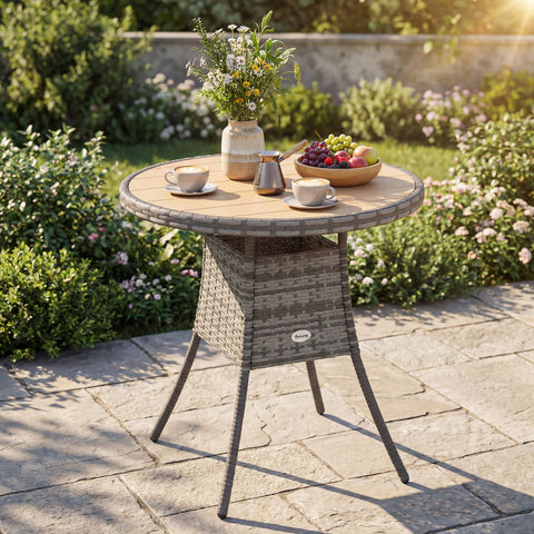 Gray woven rattan dining table with round natural wood top and storage, featuring galvanised steel frame for outdoor use