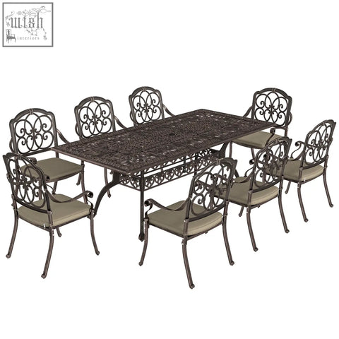 Dark bronze cast aluminium garden dining set with ornate scrollwork beige cushioned seats and parasol hole